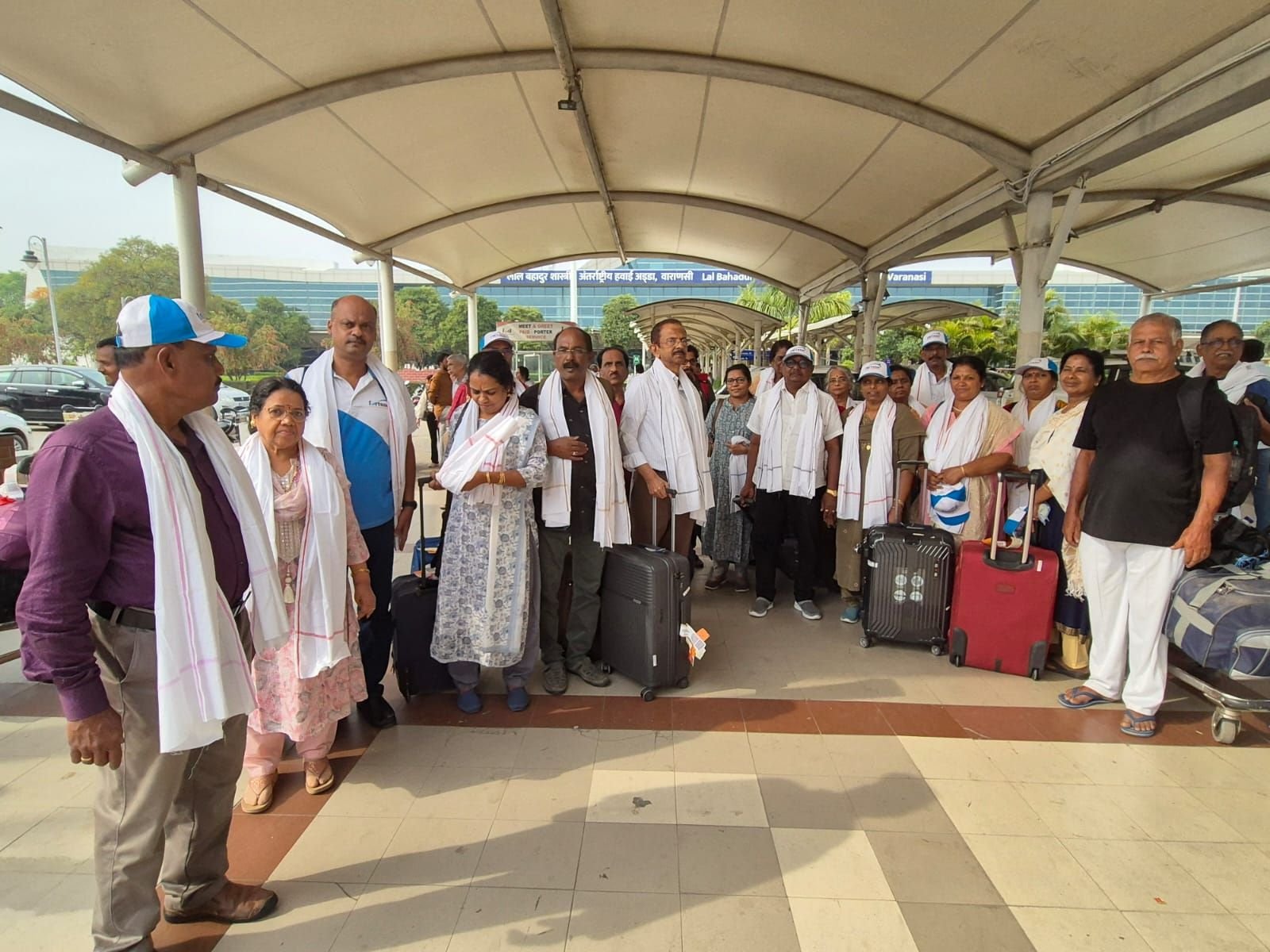 Tour guests arriving at Lal Bahadur Shastri Airport in Varanasi, greeted by travel representatives for their pilgrimage tour